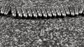 many Tokarev pistol cartridges (7.62Ãâ25mm) lying on a gray granite background, monochrome photo